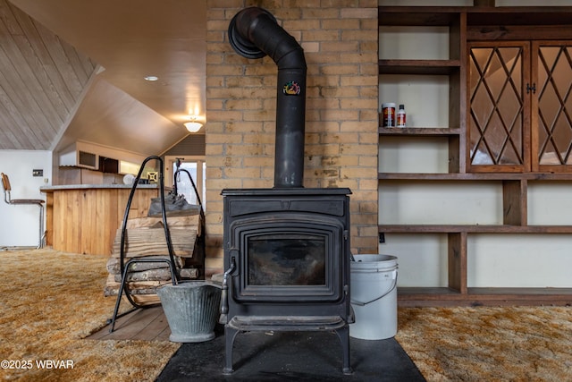 interior details featuring wood-type flooring and a wood stove