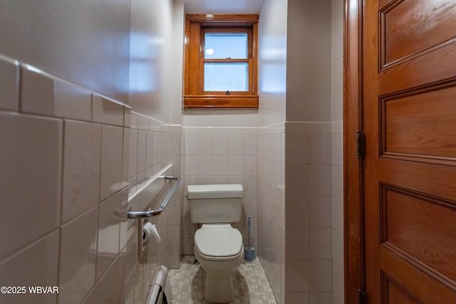 bathroom featuring tile walls, tile patterned flooring, and toilet