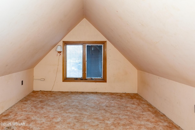 bonus room featuring vaulted ceiling and light carpet