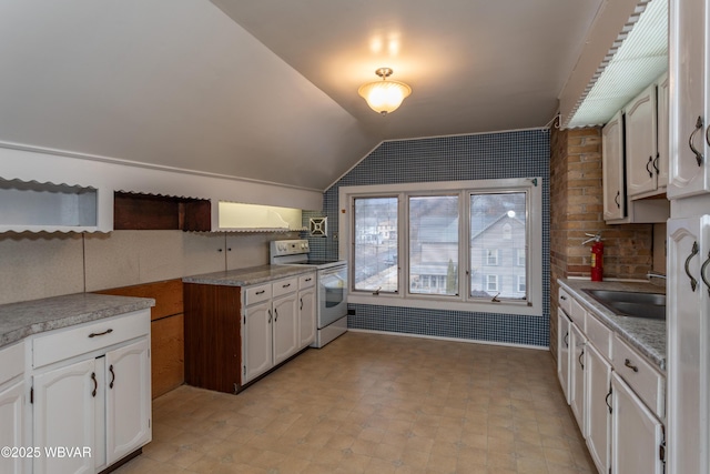 kitchen with sink, white range with electric stovetop, white cabinets, decorative backsplash, and vaulted ceiling