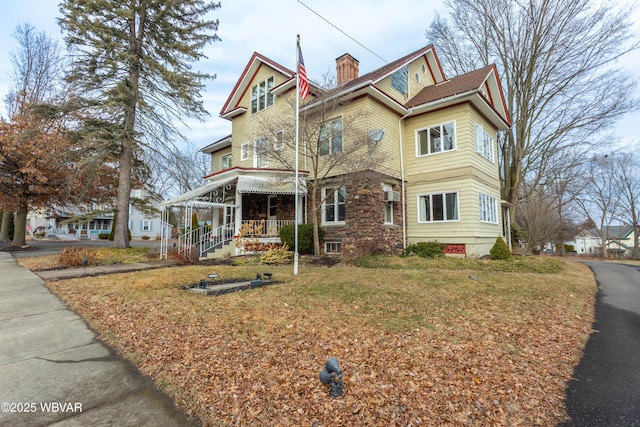 victorian home featuring a front lawn and a porch