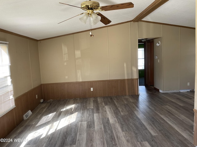 unfurnished room featuring vaulted ceiling with beams, dark wood-type flooring, ceiling fan, and a healthy amount of sunlight