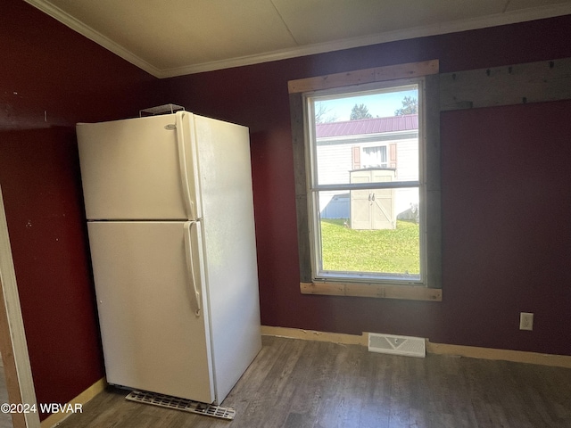 kitchen with hardwood / wood-style flooring, crown molding, and white refrigerator