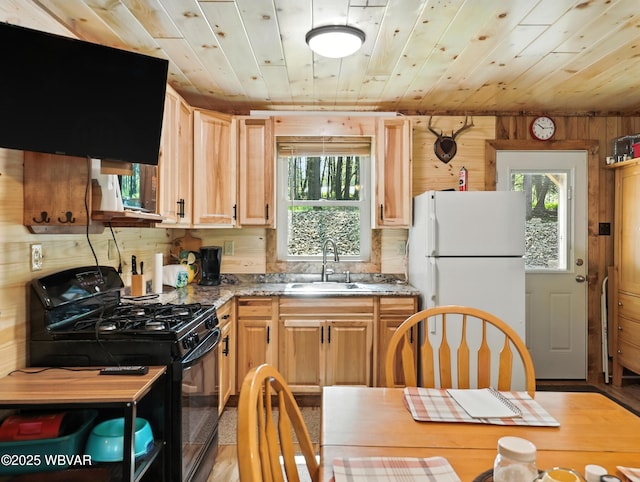 110 Worlds End Rd, Muncy Valley, PA 17758 - kitchen with black gas stove, freestanding refrigerator, plenty of natural light, ventilation hood, and wood ceiling