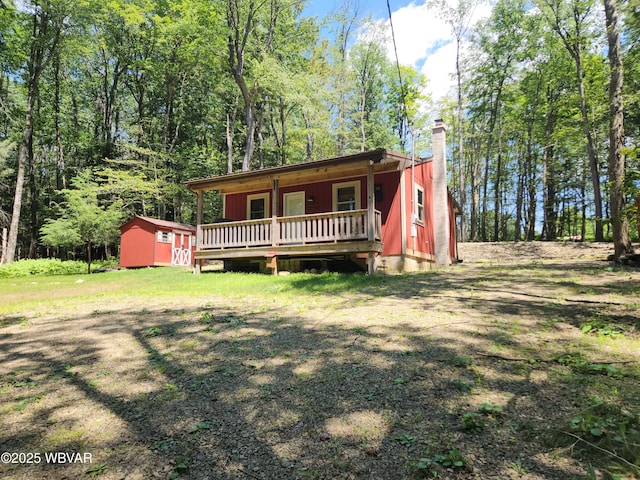 110 Worlds End Rd, Muncy Valley, PA 17758 - view of front of home with a chimney, a storage shed, and a deck