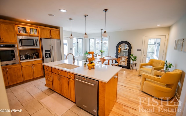 335 Chirlton Pt, Montoursville, PA 17754 - kitchen with appliances with stainless steel finishes, a sink, brown cabinetry, plenty of natural light, and recessed lighting