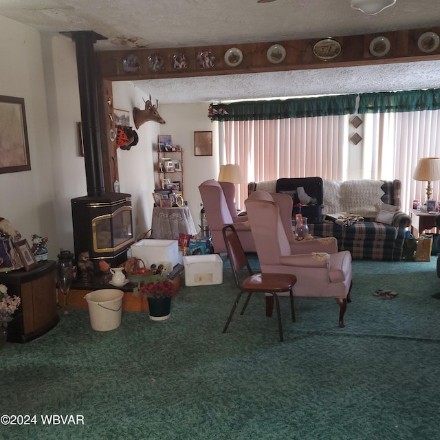 carpeted living room featuring a wood stove and a textured ceiling