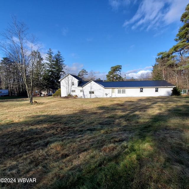 view of side of property with a lawn