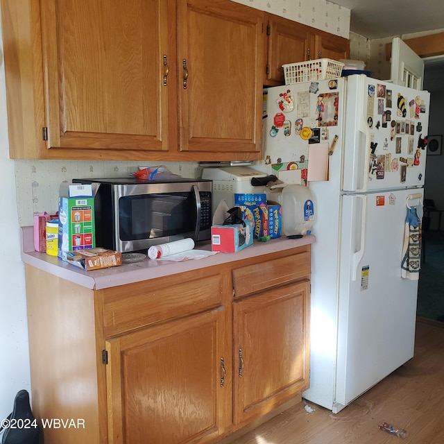 kitchen with white refrigerator and light wood-type flooring