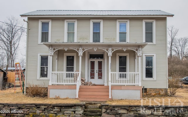 view of front facade with covered porch and metal roof