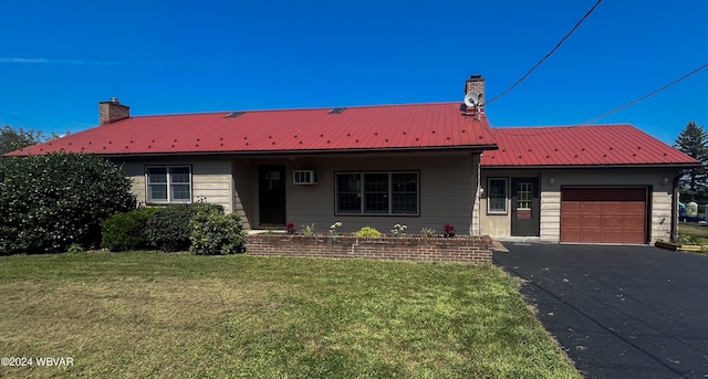 single story home with a garage and a front lawn