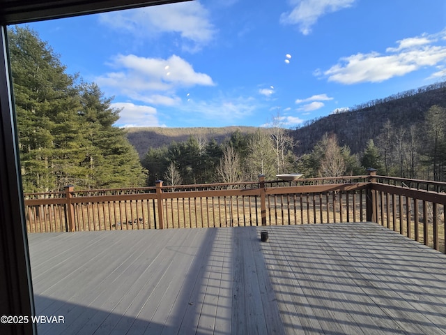 wooden deck with a view of trees