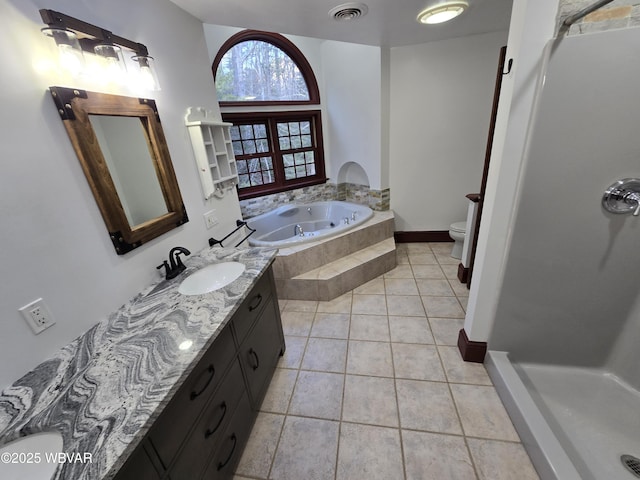 bathroom with vanity, visible vents, tile patterned flooring, a garden tub, and toilet