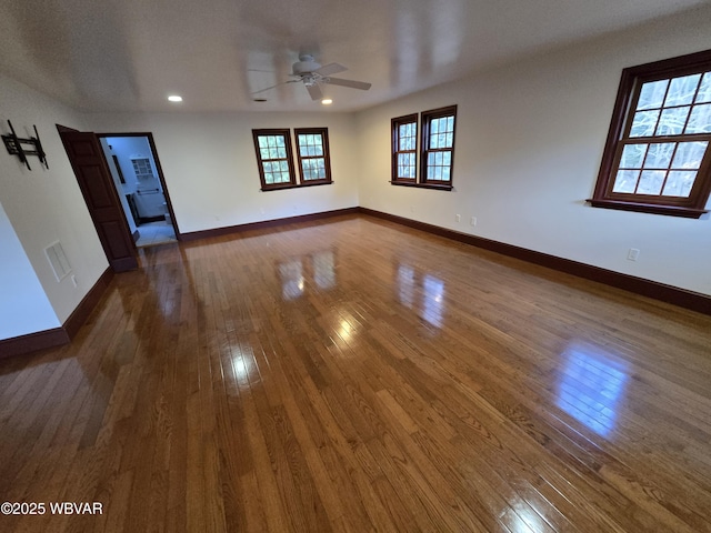 unfurnished room featuring a ceiling fan, recessed lighting, dark wood-style floors, and baseboards