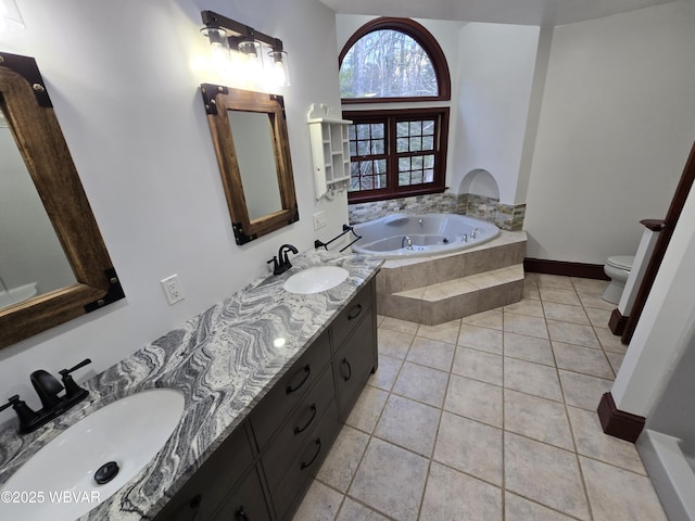 full bath featuring tile patterned flooring, toilet, a garden tub, and a sink