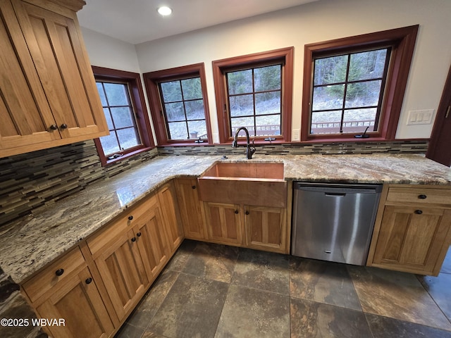 kitchen with a sink, recessed lighting, decorative backsplash, light stone countertops, and dishwasher