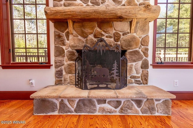 room details with wood finished floors, a fireplace, and baseboards