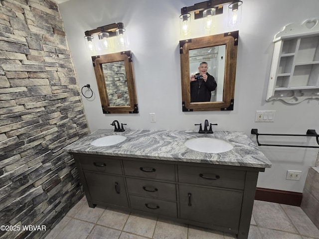 full bath with double vanity and a sink