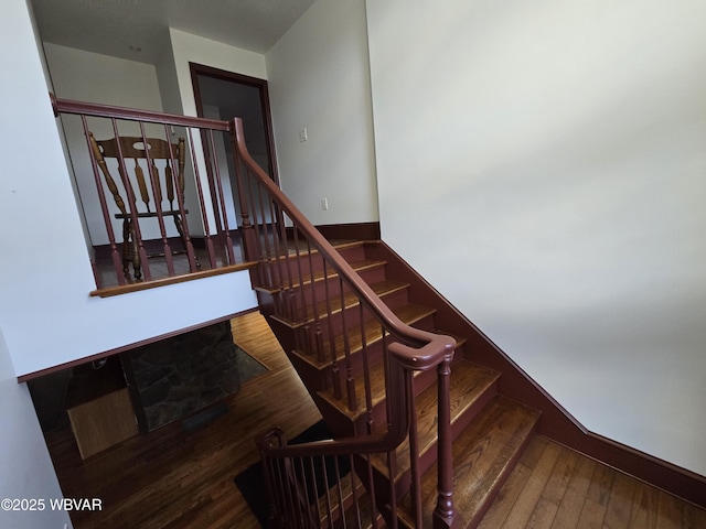 stairway with baseboards and wood finished floors