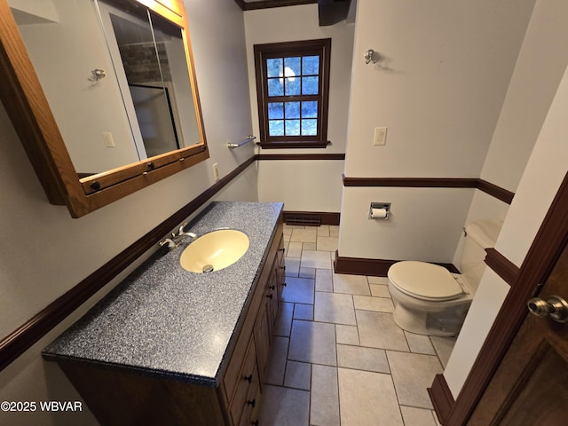 bathroom with vanity, toilet, visible vents, and baseboards