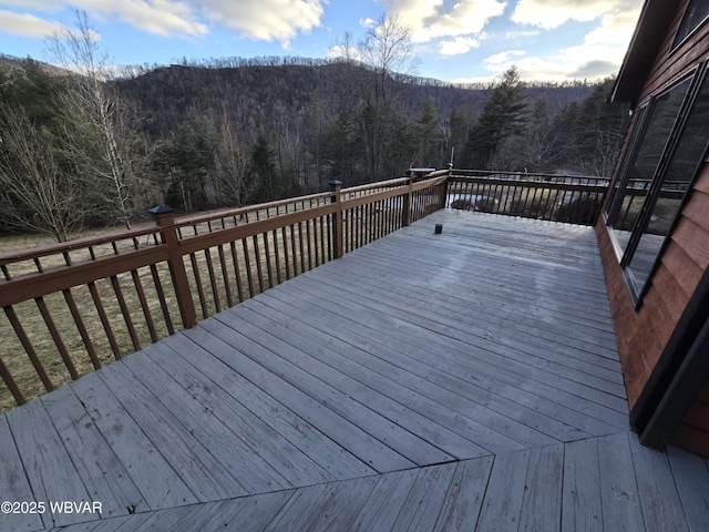 wooden terrace with a wooded view