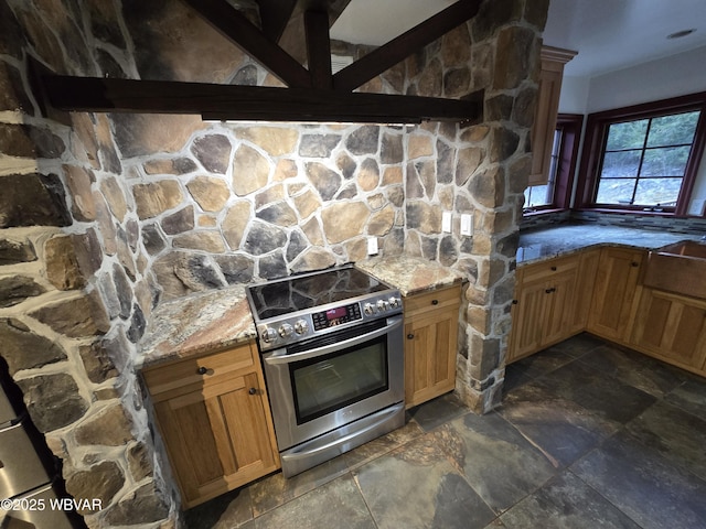 kitchen featuring light stone counters, electric range, and stone finish flooring