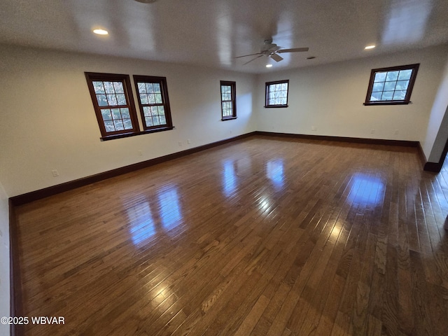 spare room with dark wood finished floors, recessed lighting, baseboards, and ceiling fan