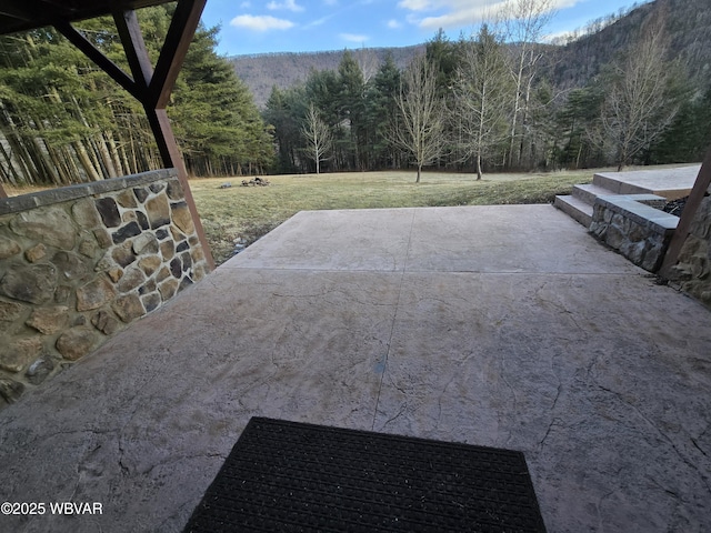 view of patio with a wooded view