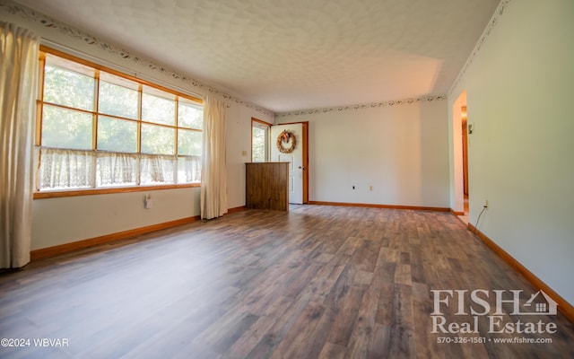 unfurnished room with hardwood / wood-style floors