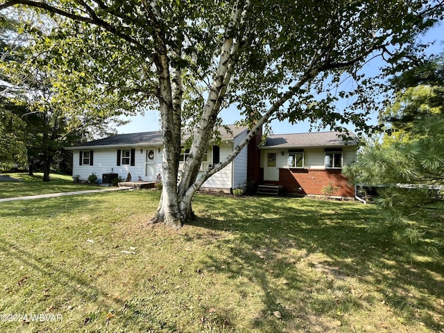 rear view of property with a yard and central AC unit