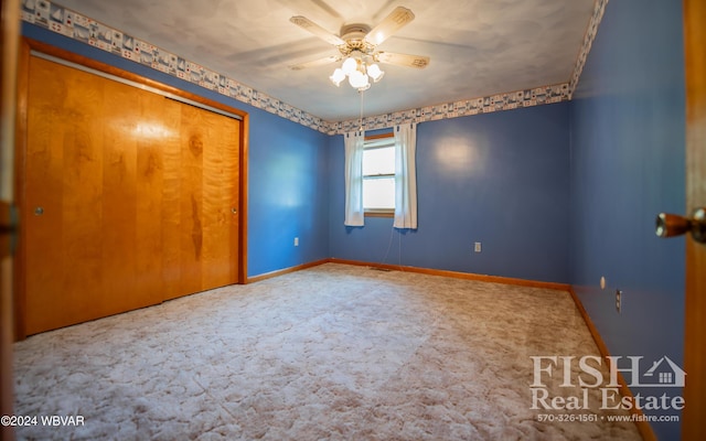 unfurnished bedroom with carpet floors, a closet, and ceiling fan