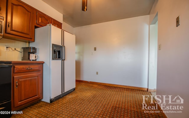 kitchen featuring backsplash and white fridge with ice dispenser