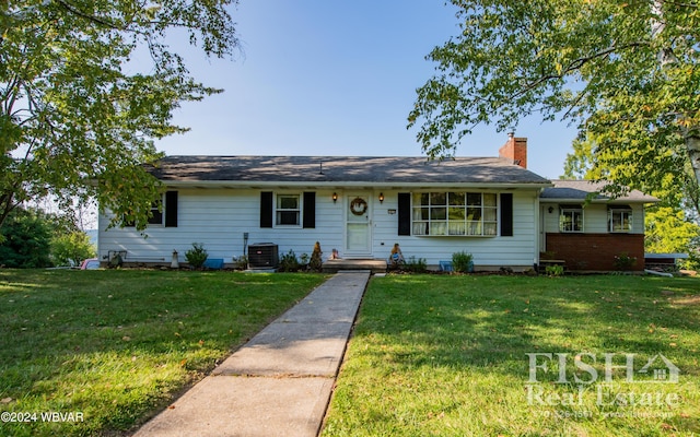 ranch-style house featuring central AC unit and a front yard