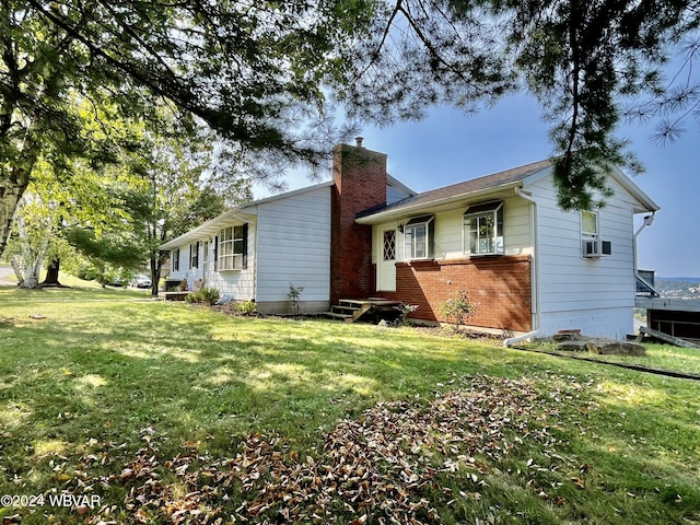 exterior space with cooling unit and a front yard