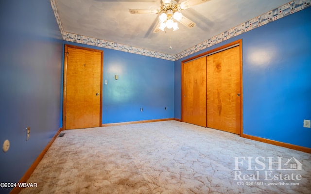 unfurnished bedroom with ceiling fan, carpet floors, and a closet