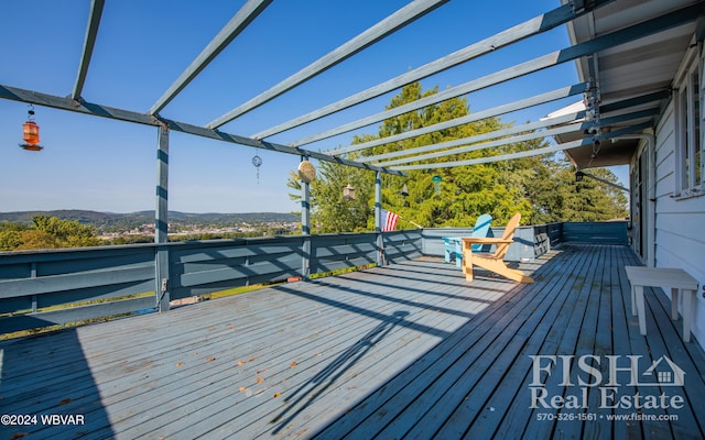 wooden terrace with a mountain view and a pergola