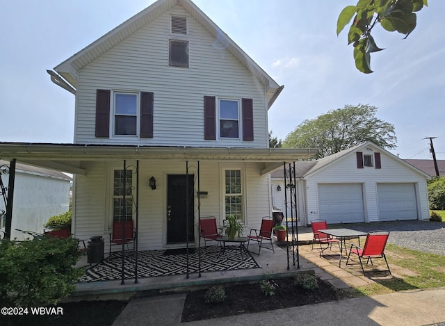 front of property featuring an outdoor structure, a porch, and a garage