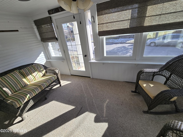 sunroom / solarium featuring ceiling fan