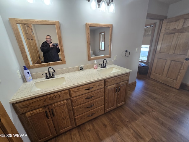 bathroom featuring hardwood / wood-style floors, vanity, and toilet