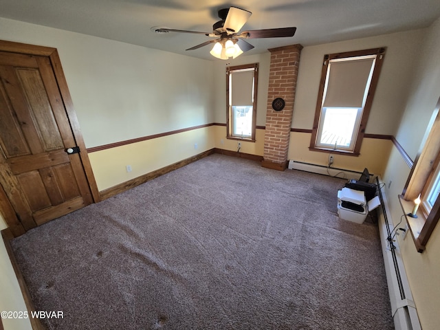 carpeted spare room featuring ceiling fan and a baseboard radiator