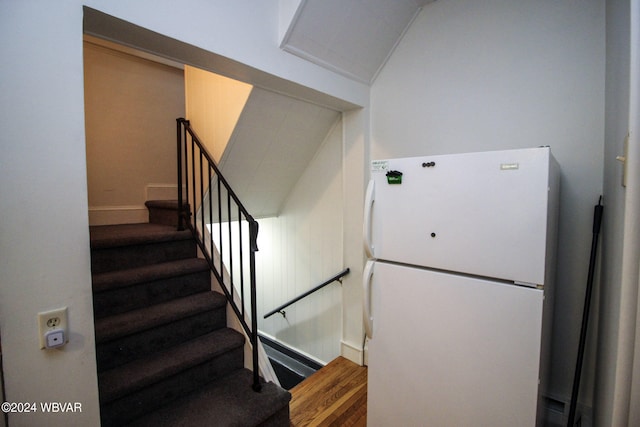 staircase with hardwood / wood-style floors