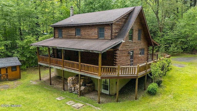 175 Hemlock Ln, Millville, PA 17846 - back of property featuring log siding, a wooden deck, a forest view, a yard, and roof with shingles