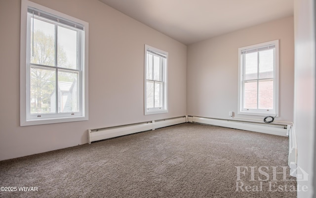 carpeted spare room with plenty of natural light and a baseboard heating unit