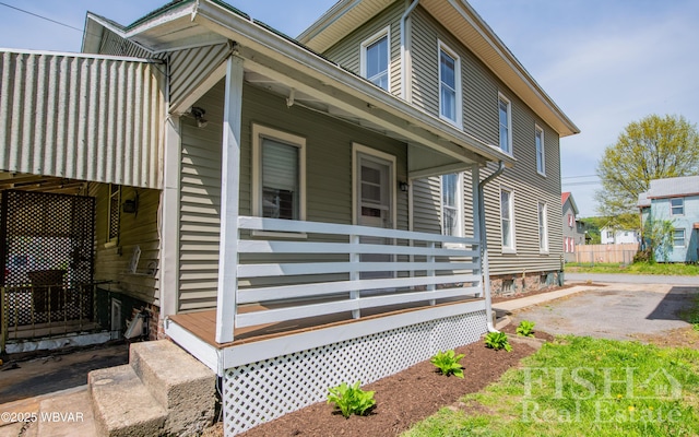 view of side of property featuring covered porch