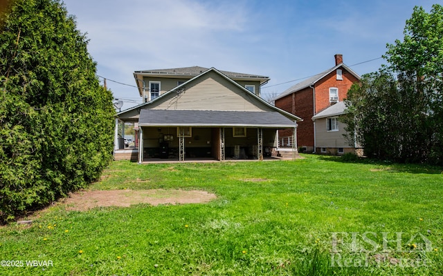 back of property with a patio and a yard