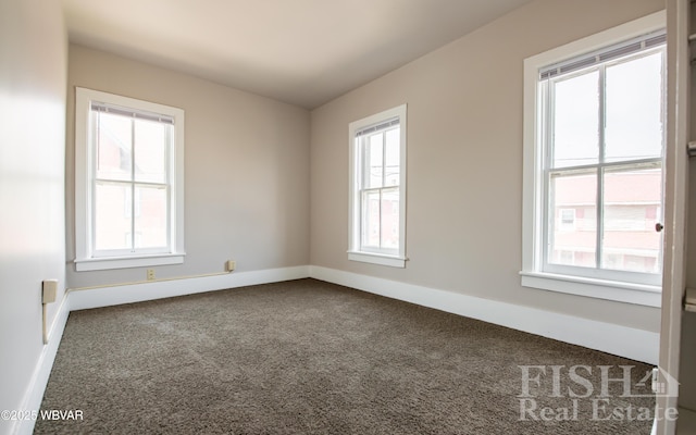 carpeted empty room with baseboards
