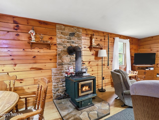 72 Carl Rd, Dushore, PA 18614 - living room with a wood stove, wood finished floors, and wood walls