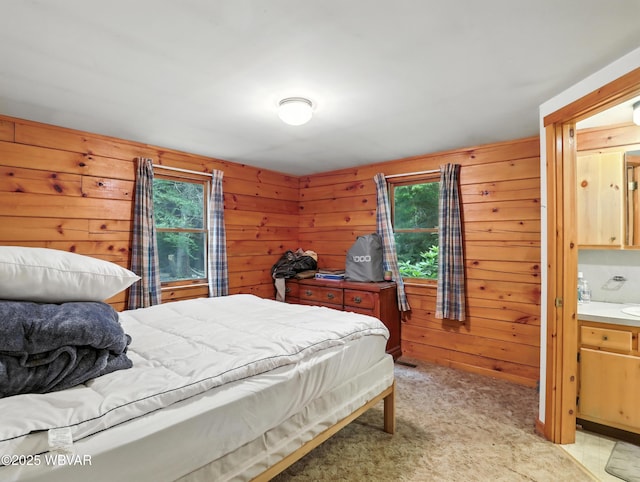 72 Carl Rd, Dushore, PA 18614 - bedroom with multiple windows, wooden walls, light colored carpet, and ensuite bath