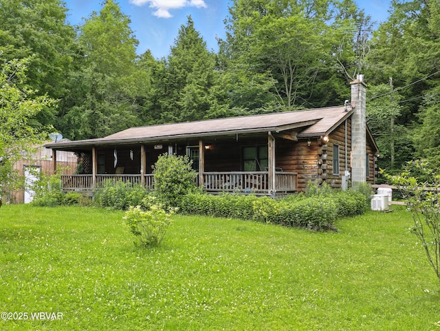 72 Carl Rd, Dushore, PA 18614 - log cabin featuring covered porch, a chimney, a front lawn, and log siding