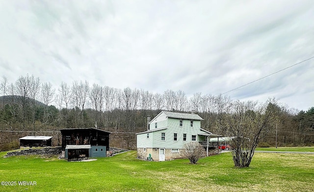 2155 Slacks Run Rd, Trout Run, PA 17771 - view of side of property featuring a lawn, a wooded view, and a chimney